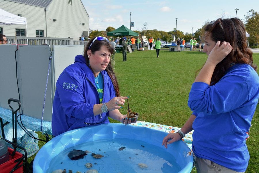 Tracy Marcus of Cornell and Allie Sliney, a FINS intern from New Hampshire, at the touch tank.