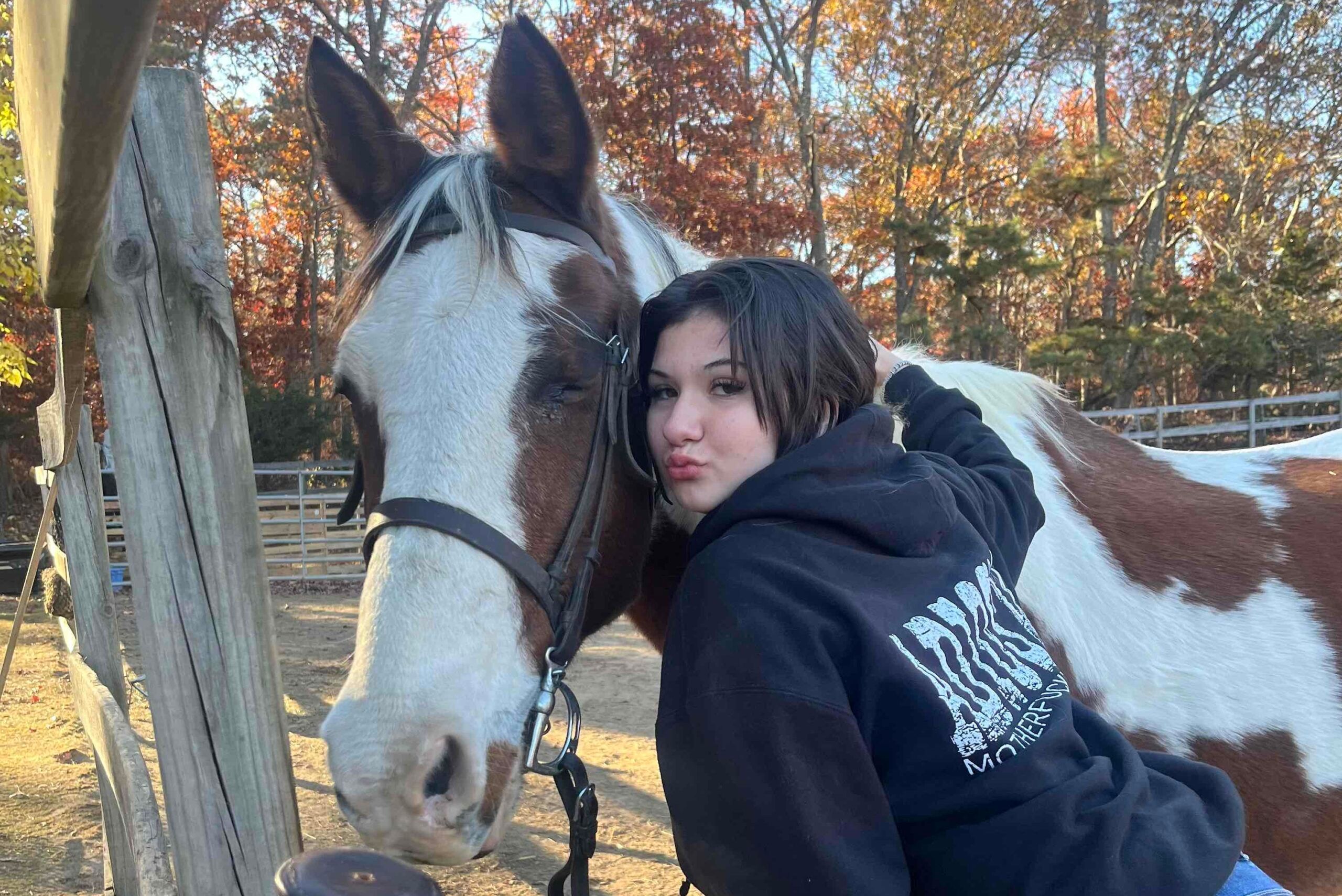 Photo of missing Patchogue teen Emmarae Gervasi with a house on a farm.