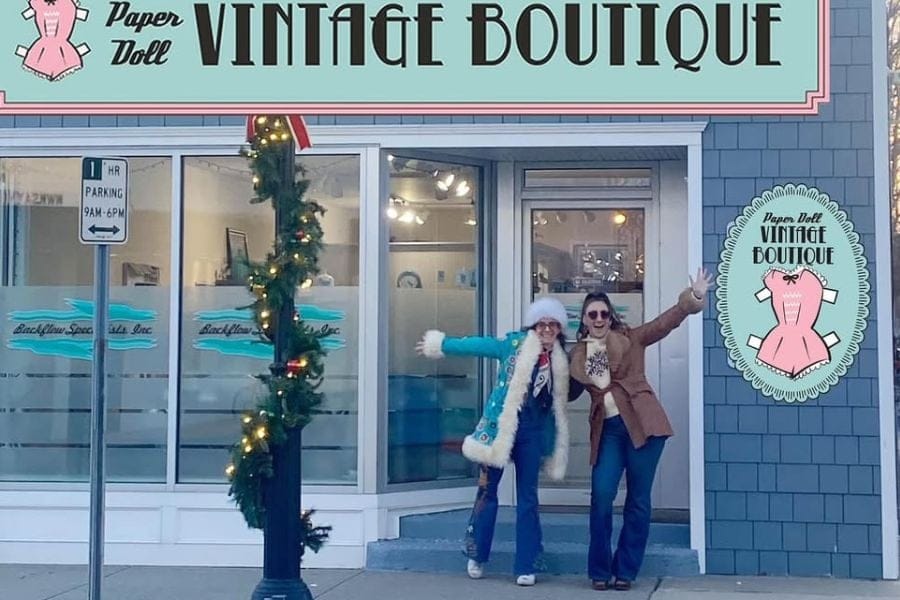 Two women in front of storefront.