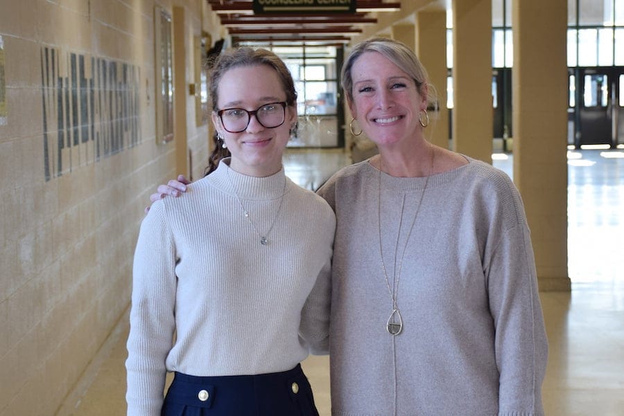 Two women standing in a school.