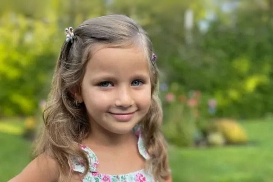 Portrait of Arya Parikh, a smiling 6-year-old girl with bright eyes and a joyful expression.