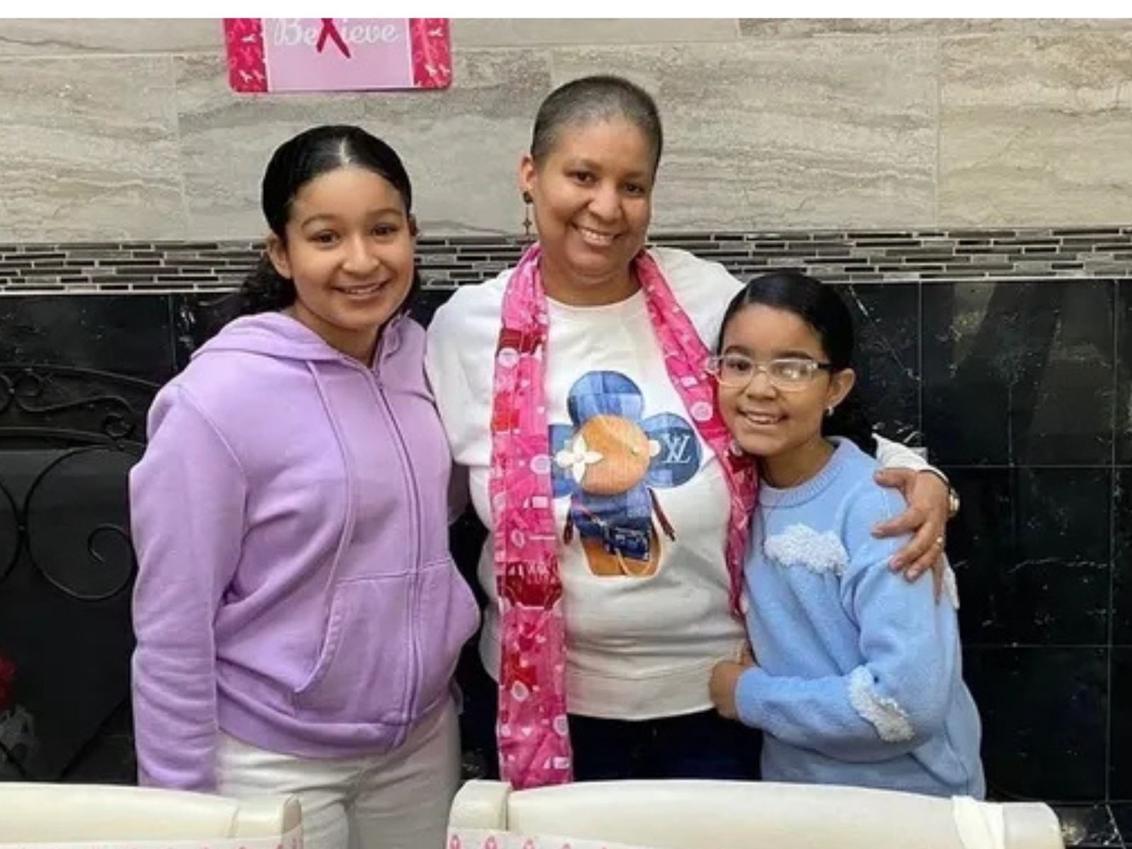 Josefina Hernandez smiling with her teenage daughters.