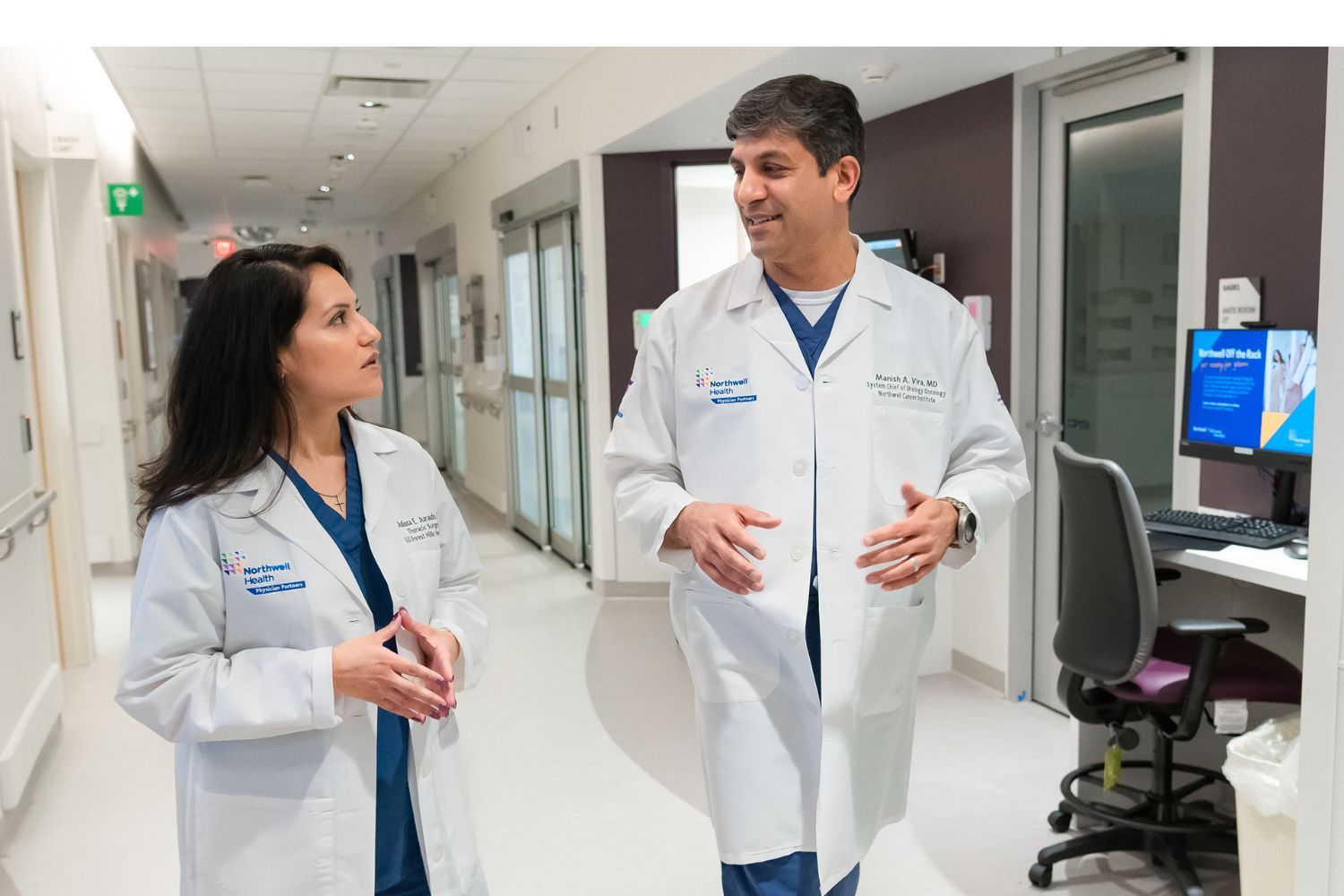 Northwell Health doctors in hospital hallway.
