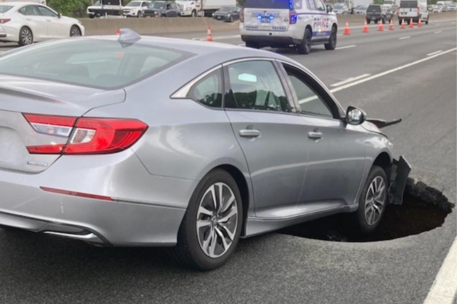 Car nose-first in sinkhold on Long Island Expressway