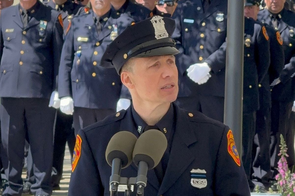 Suffolk PBA President Lou Civello in uniform at podium, while speaking.