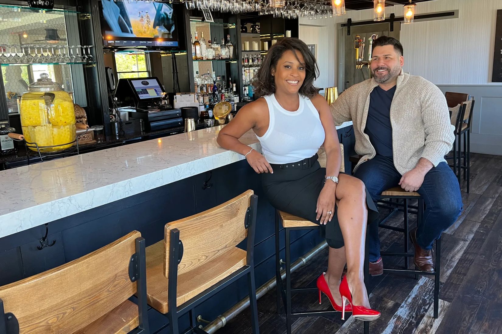 Abigail's owners Patricia Rincon and James Mangiacapre seated at a bar.