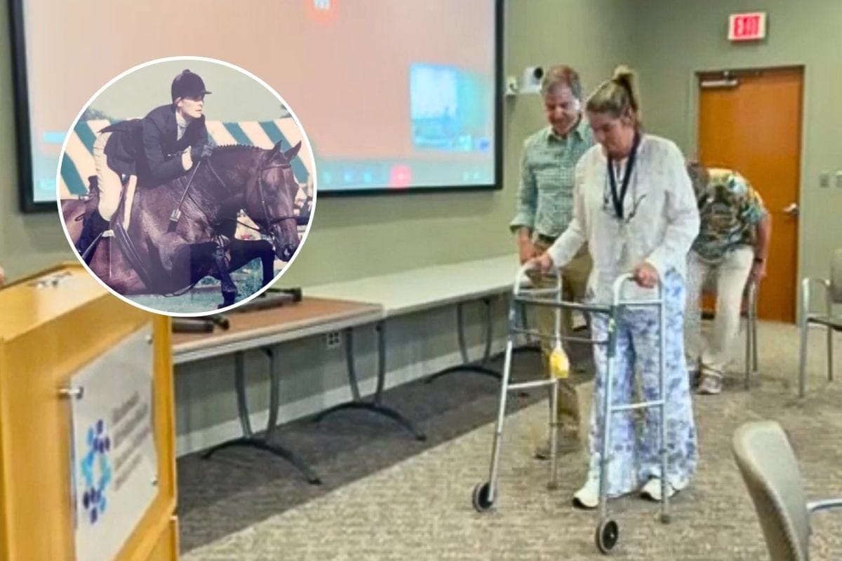 Jennifer Post Rudolph walks to the podium using a walker.