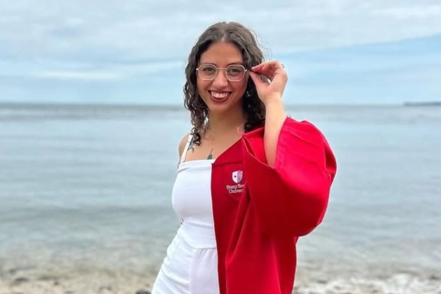 Victoria Castle in Stony Brook graduation gown on the beach.
