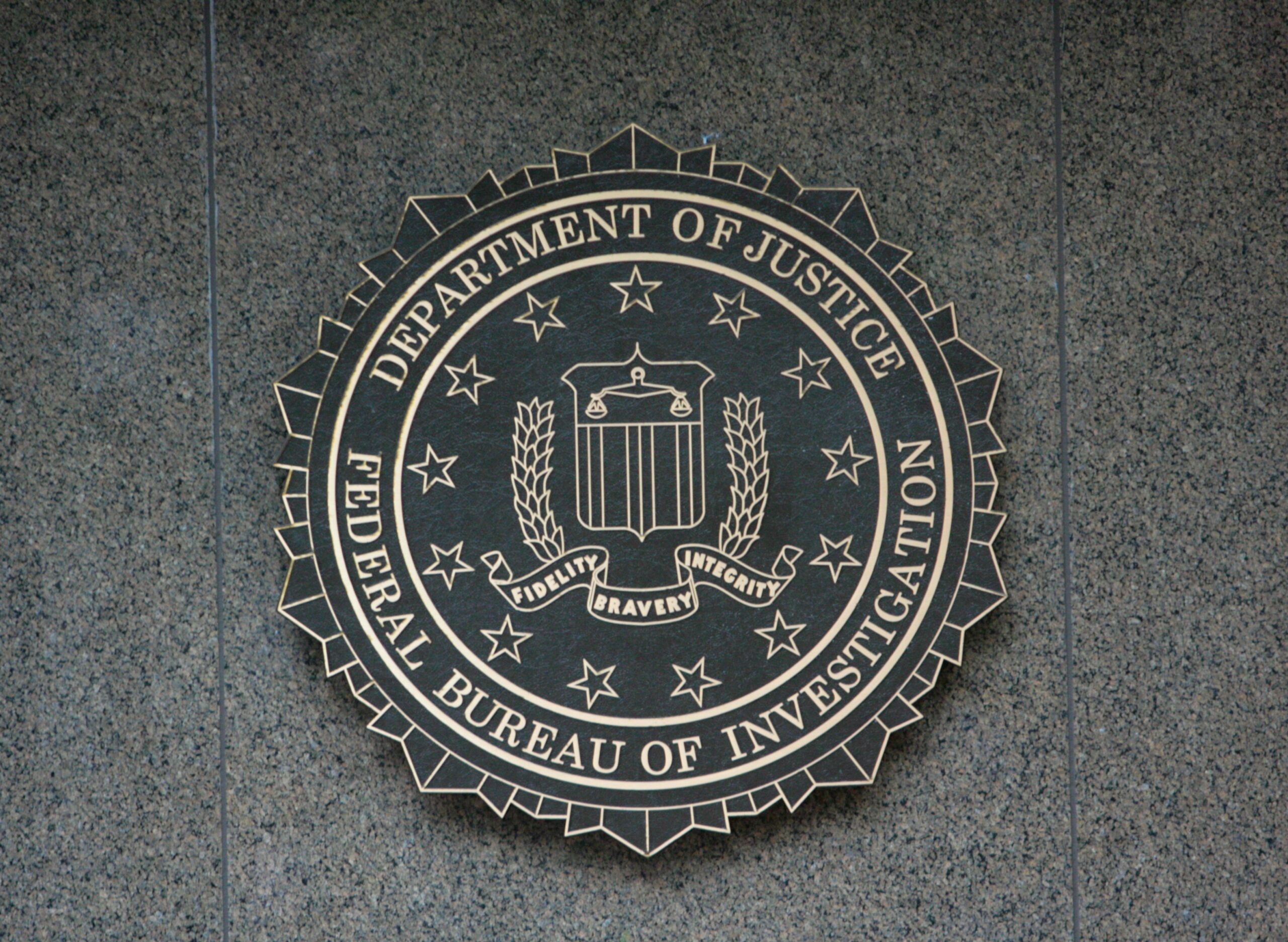 FBI / Department of Justice sign on building, representing Connecticut woman arrested for coercion of teen boy.