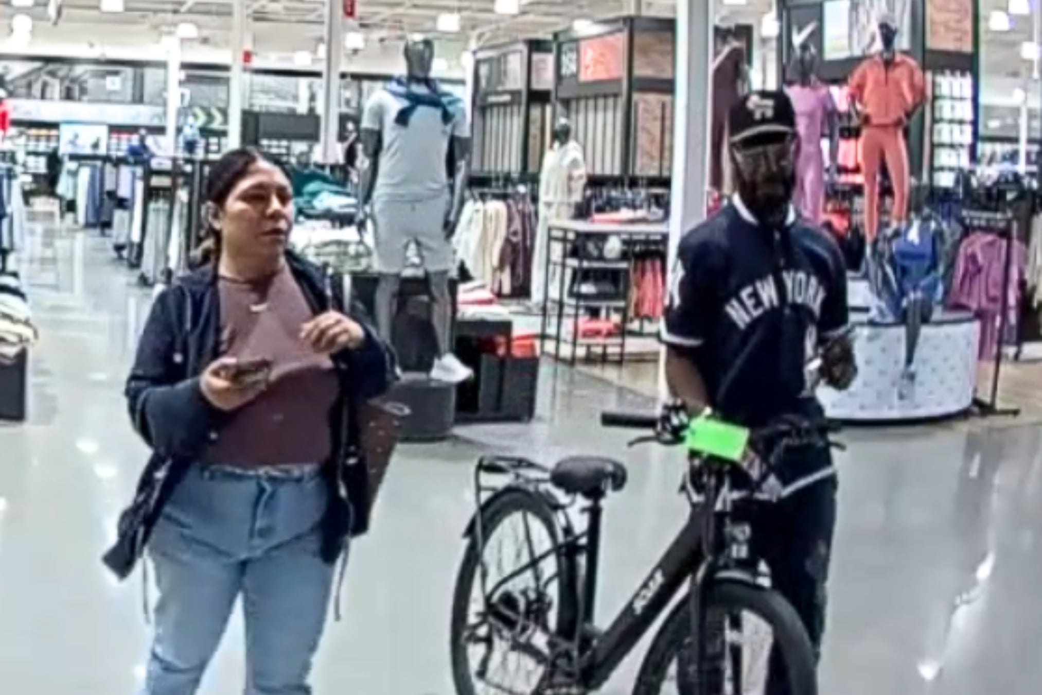 Surveillance photo of a man and woman with a stolen electric bike inside Dick's Sporting Goods in Melville.