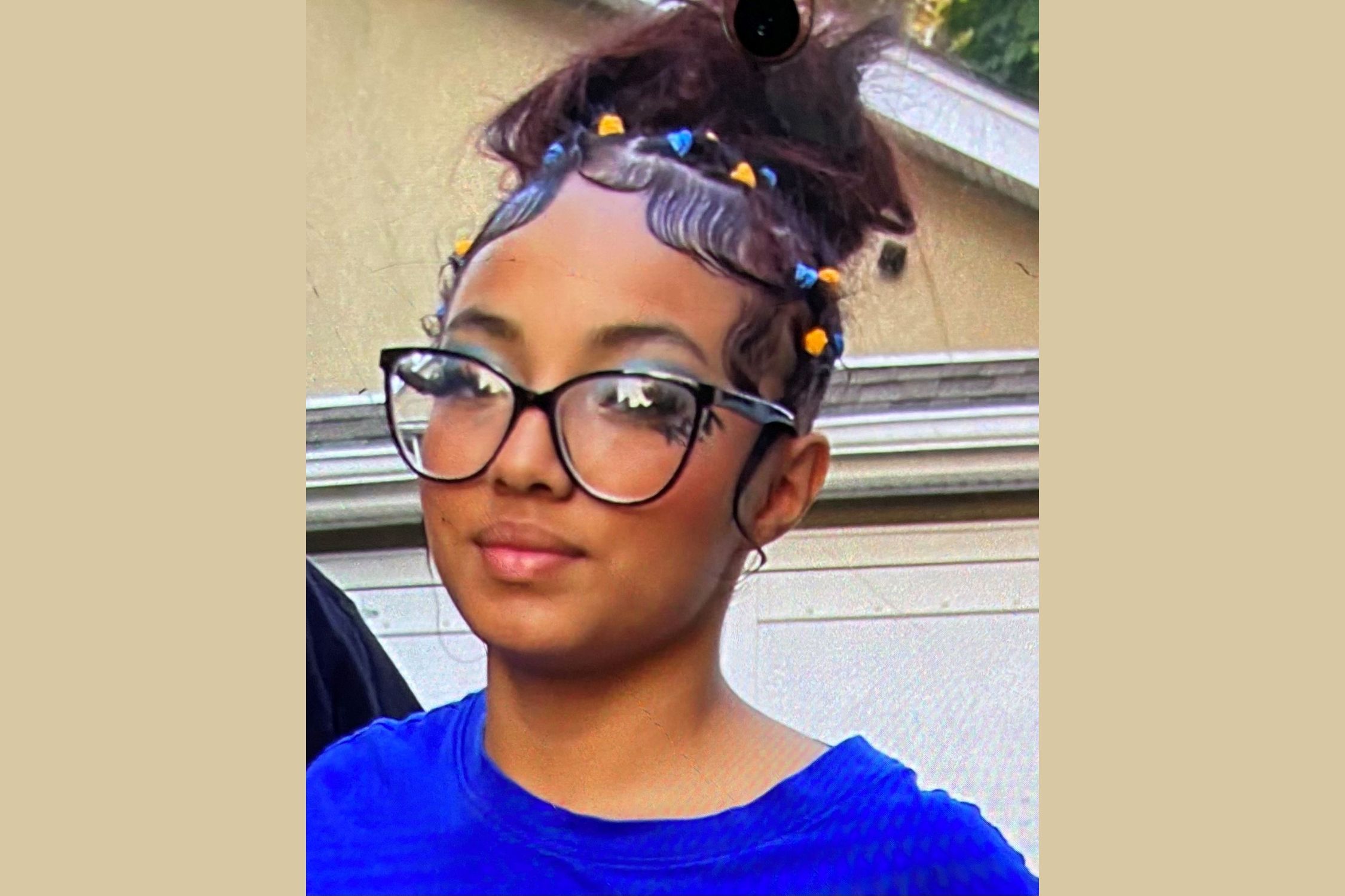Missing New Cassel girl with hair pulled back and wearing glasses.