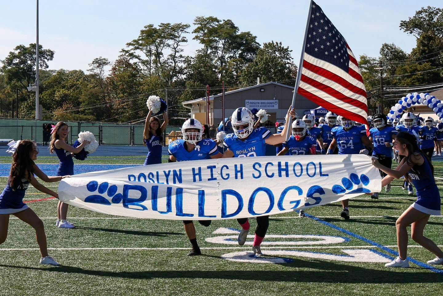 Roslyn High School football game entrance of team.