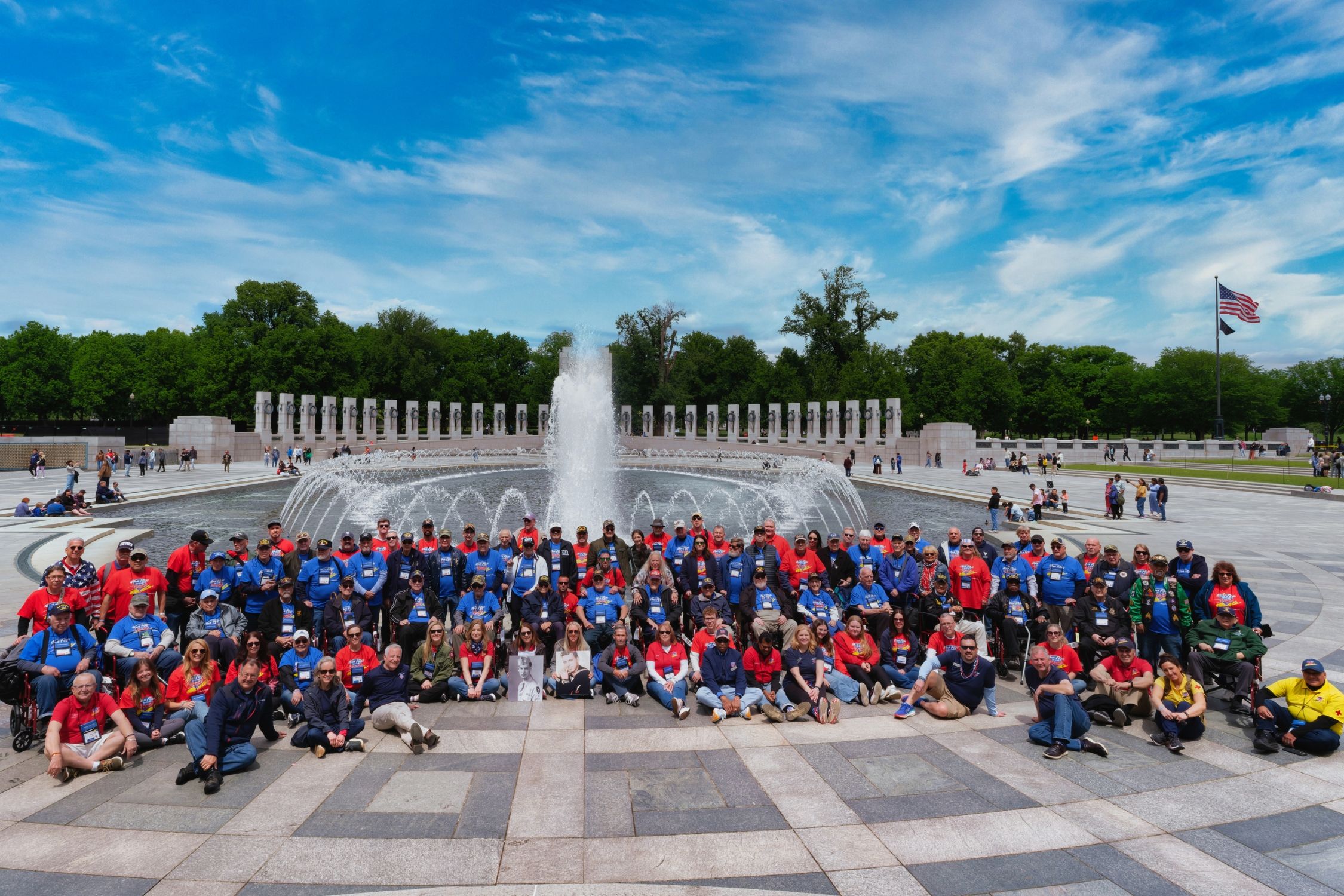 Group photo of veterans gathered at a memorial in Washington.
