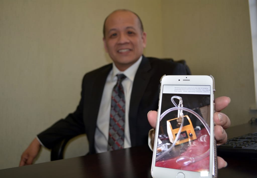 Dr. Enoch Chan of Bayport shows off a marijuana vaporizer.