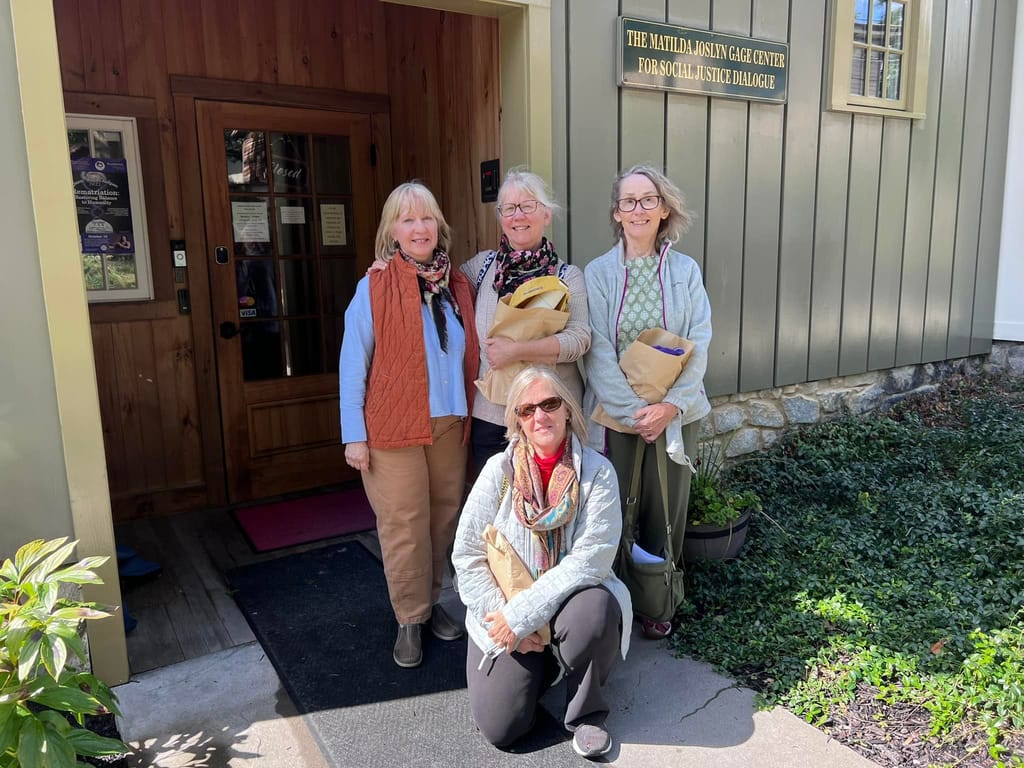Four women in front of a building.