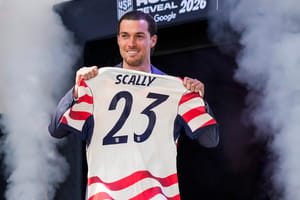 Joe Scally holds up his No. 23 jersey that he'll wear while competing for the U.S. team in the World Cup this summer.
