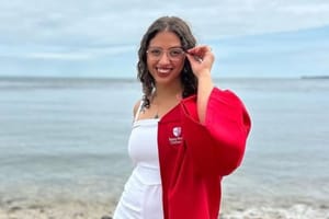 Victoria Castle in Stony Brook graduation gown on the beach.