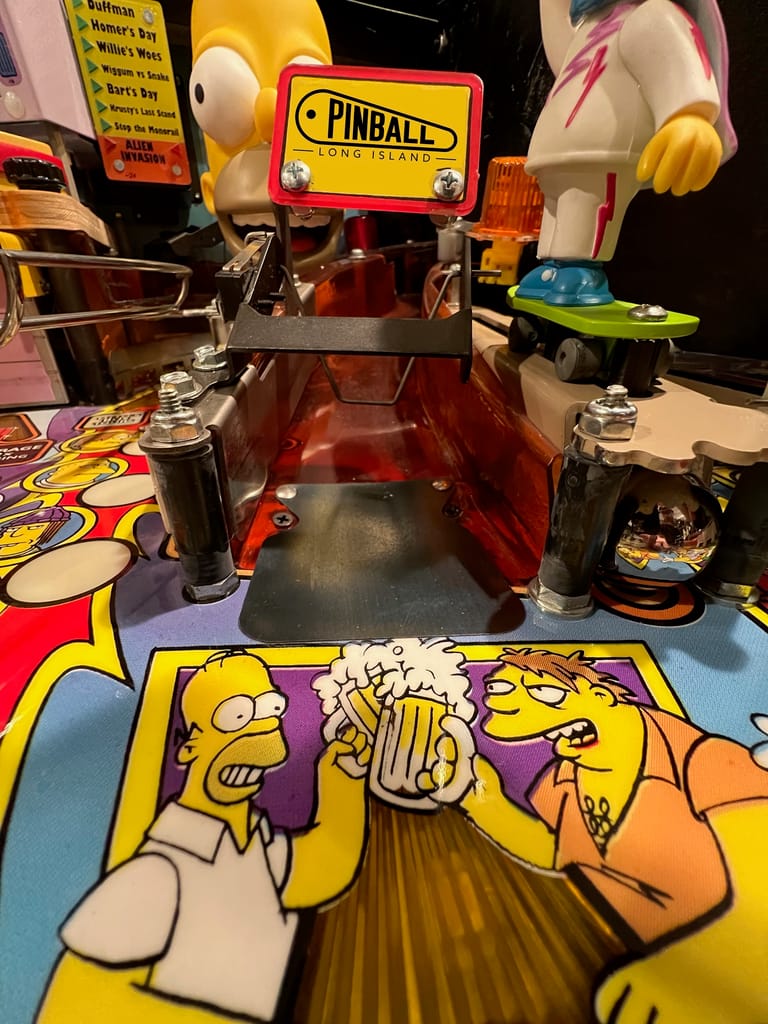 Homer and Barney each enjoy a mug of cold Duff Beer at the Simpsons pinball game at Pinball Long Island. (courtesy)