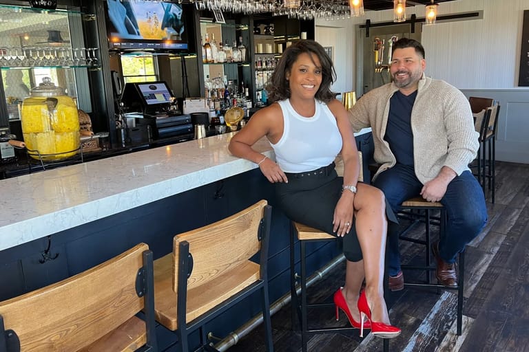 Abigail's owners Patricia Rincon and James Mangiacapre seated at a bar.