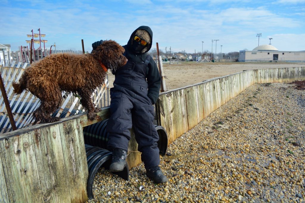 Patchogue resident Gerald Feindt and his chocolate labradoodle Mia at Shorefront Park Thursday morning. (Michael White)