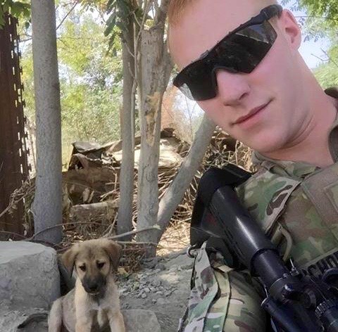 U.S. Army Specialist Holden Schoenig and his pup, Lucky.
